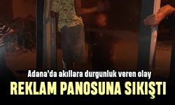 Adana'da akıllara durgunluk veren olay; reklam panosuna sıkıştı